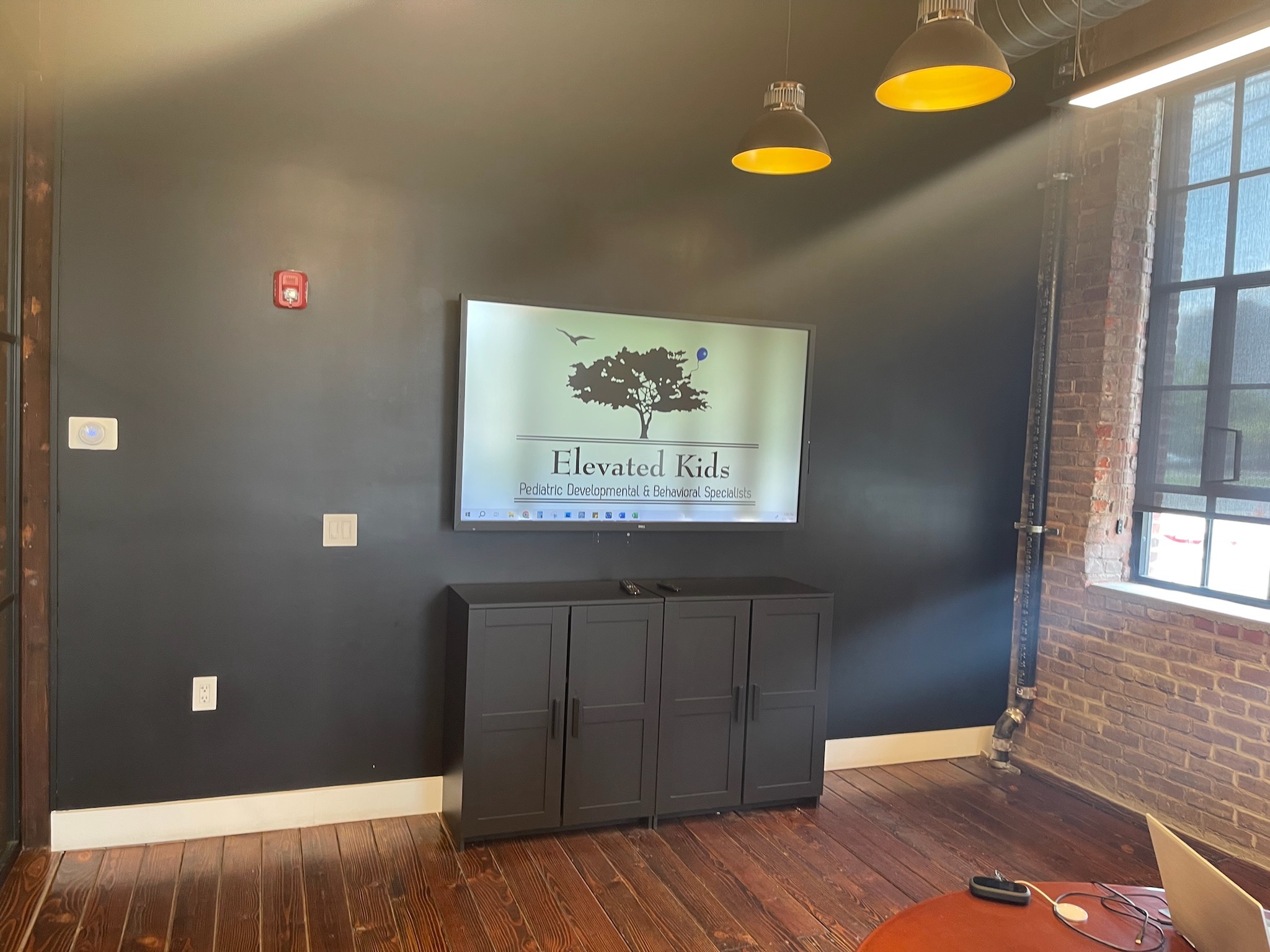 Picture of a sleek mounted TV for use in a childcare development facility.